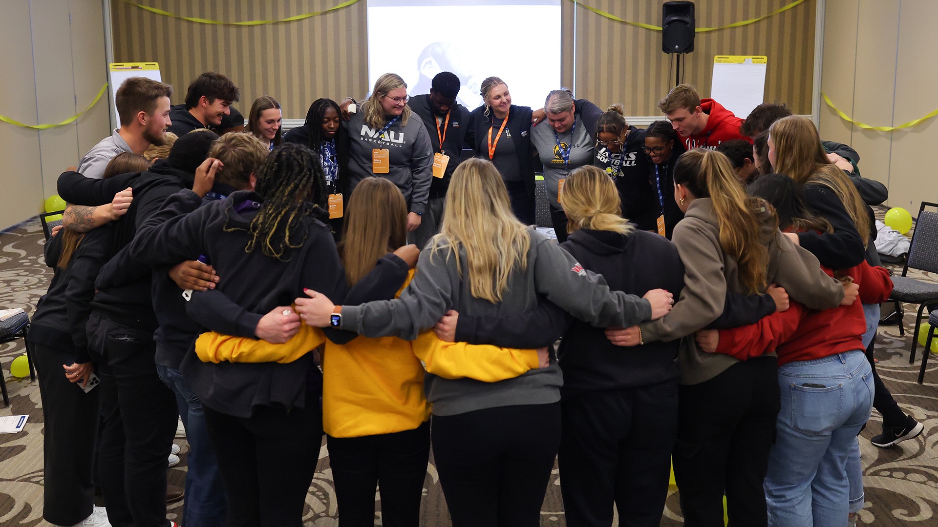 Yellow team members huddle in their room. Facilitators guided the learners through in-depth discussion about core values, emotional intelligence and inclusive leadership.