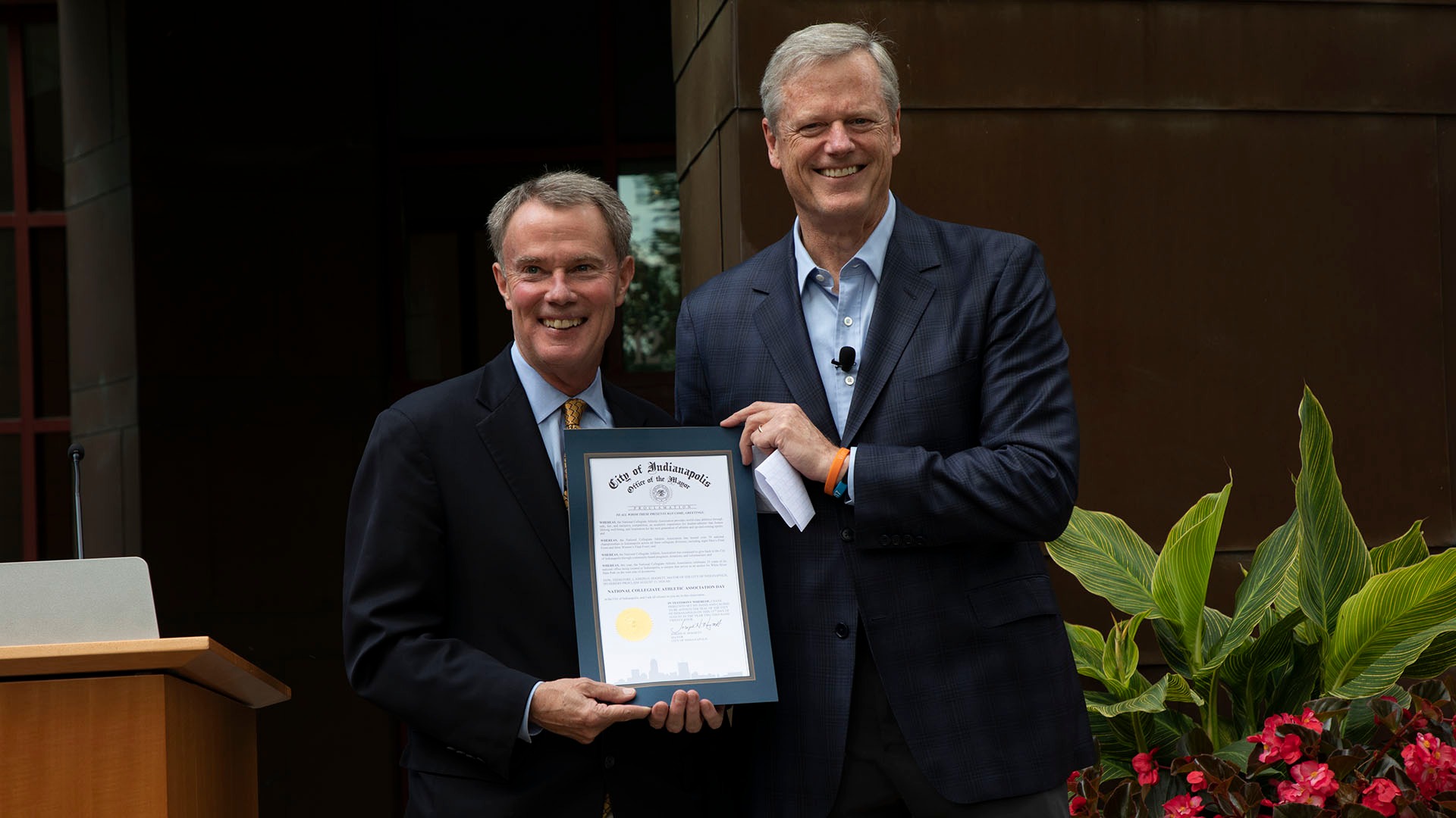 Indianapolis Mayor Joe Hogsett presents NCAA President Charlie Baker with a mayoral proclamation, stating Aug. 13, 2024 as NCAA Day.