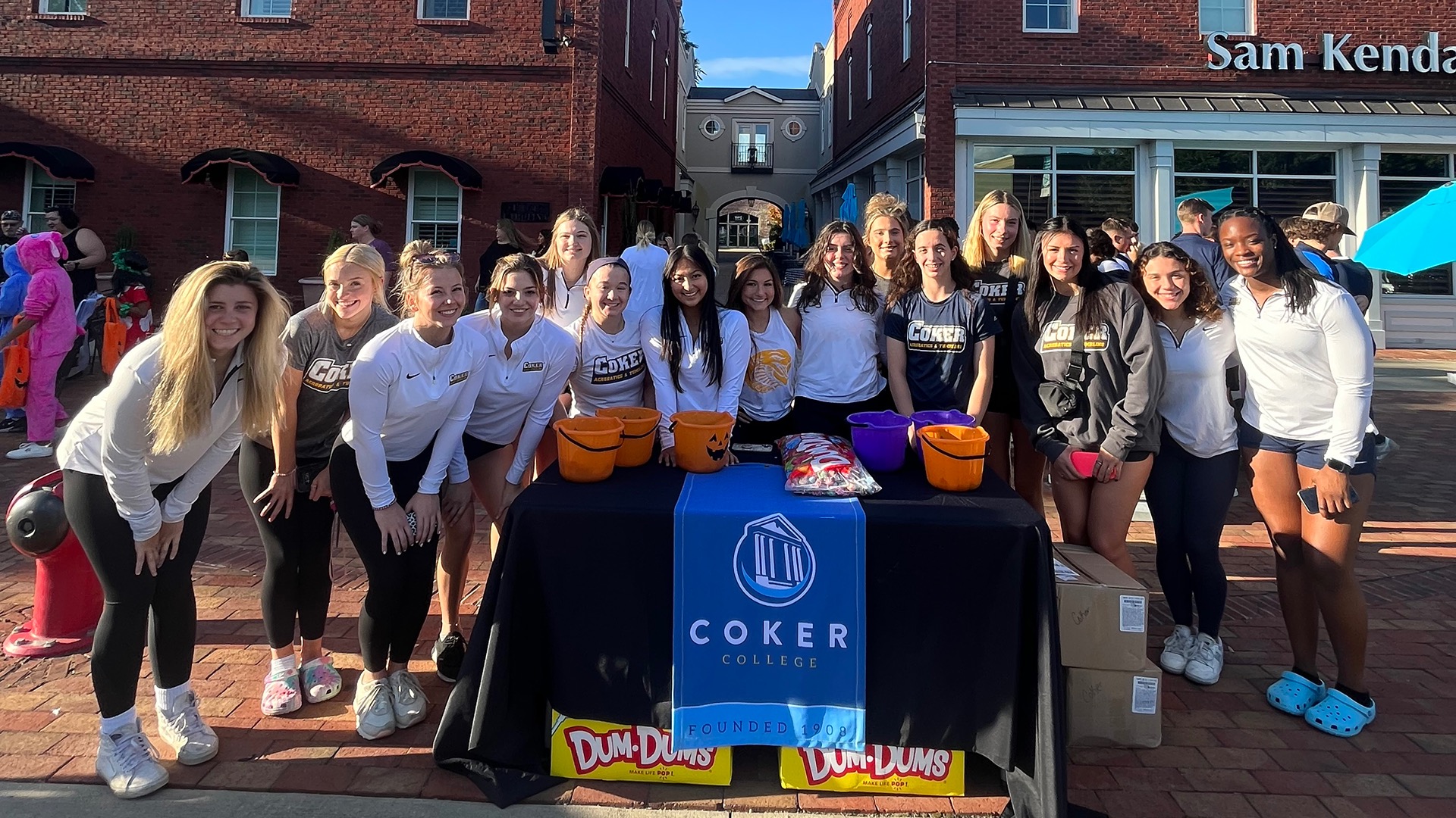 The Coker acrobatics and tumbling team hands out candy at the annual Treats on the Streets Halloween event in Hartsville, South Carolina.