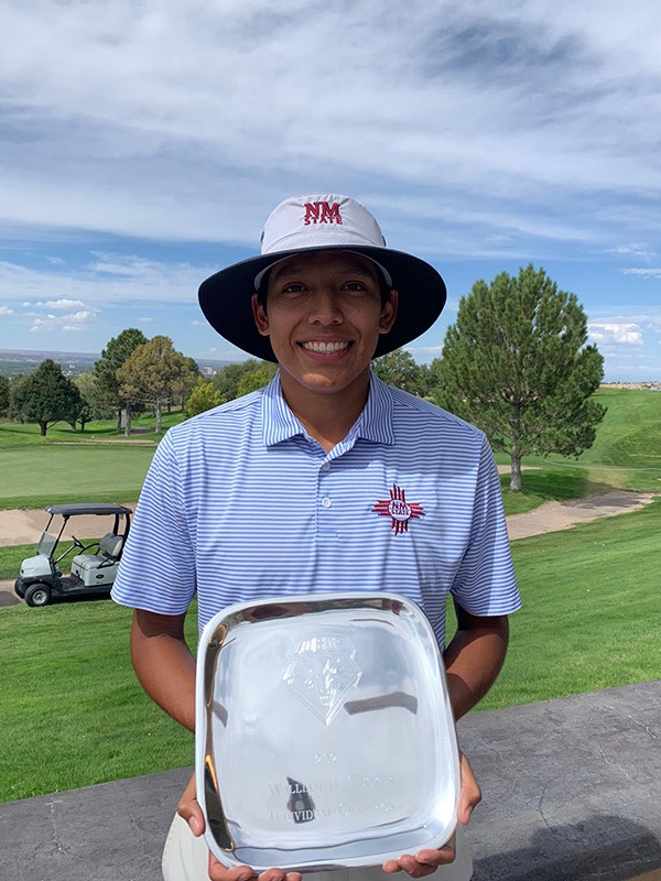 Aidan Thomas poses with his trophy after winning the individual championship at the William H. Tucker Invitational in Albuquerque, New Mexico.