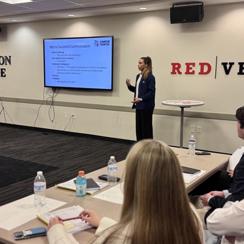 Tillman guides a group of student-athletes through a DiSC personality assessment.