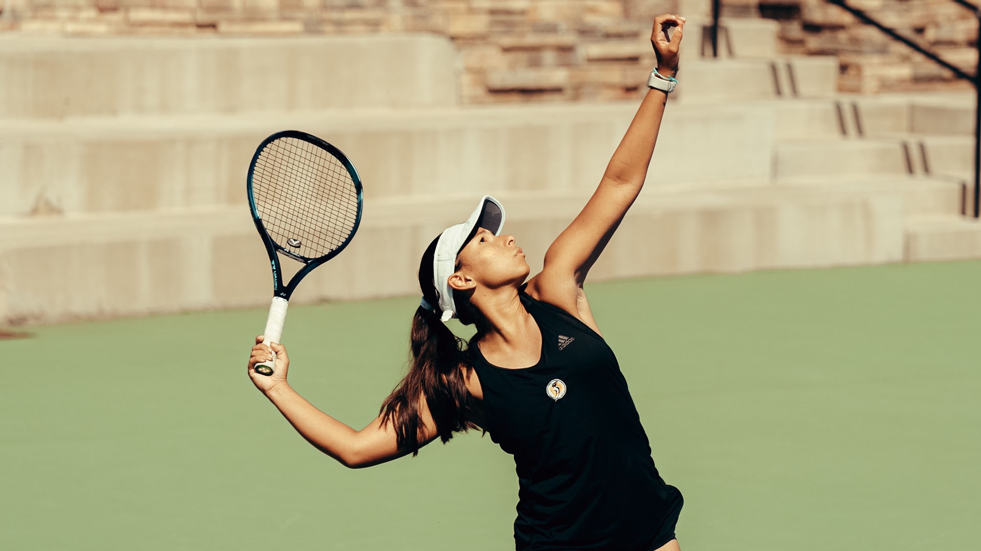 Ana Rios serves during a Dominican (California) women's tennis match. (Photos courtesy of Dominican)