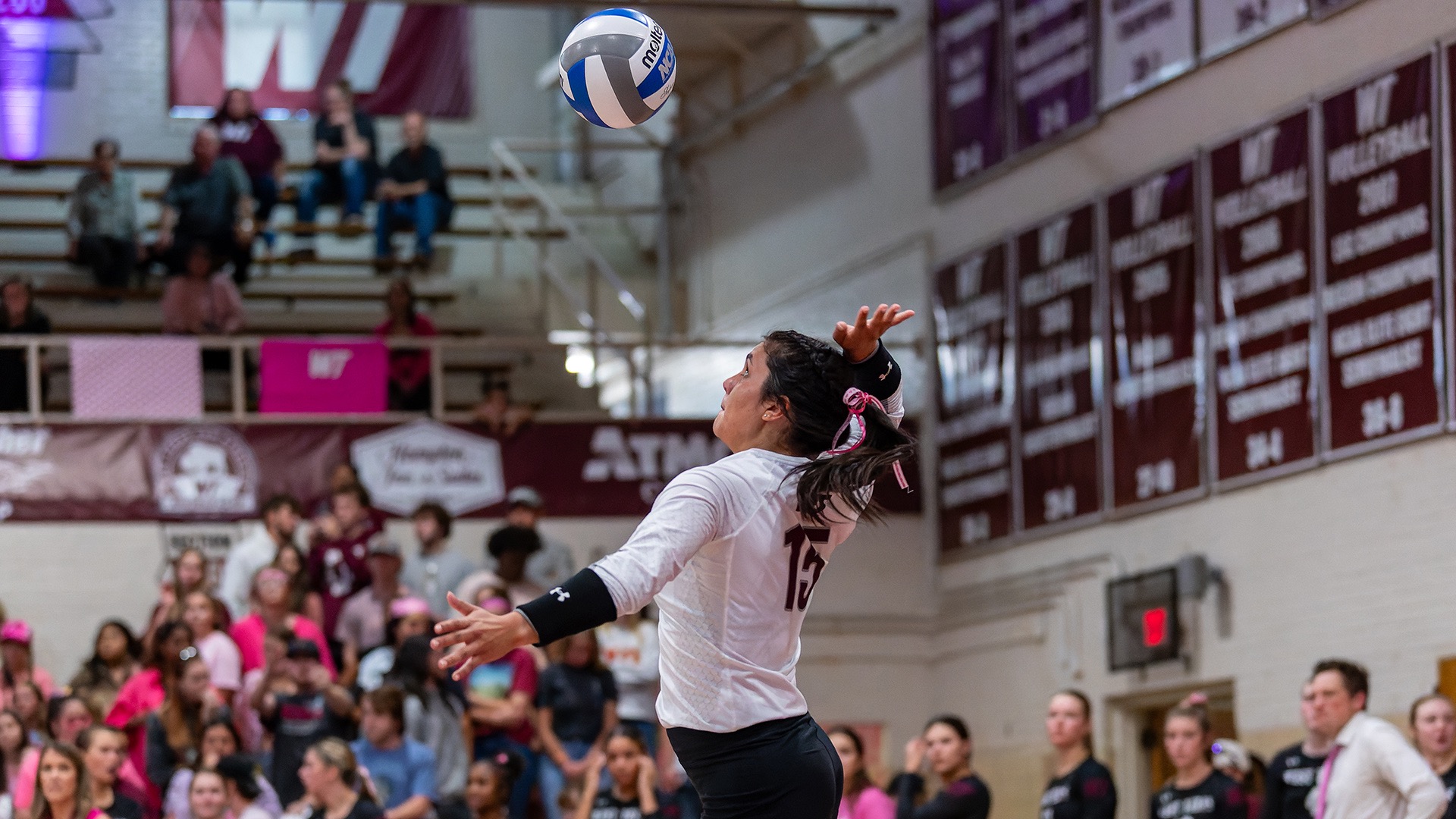Bryli Contreras serving during a West Texas A&M match
