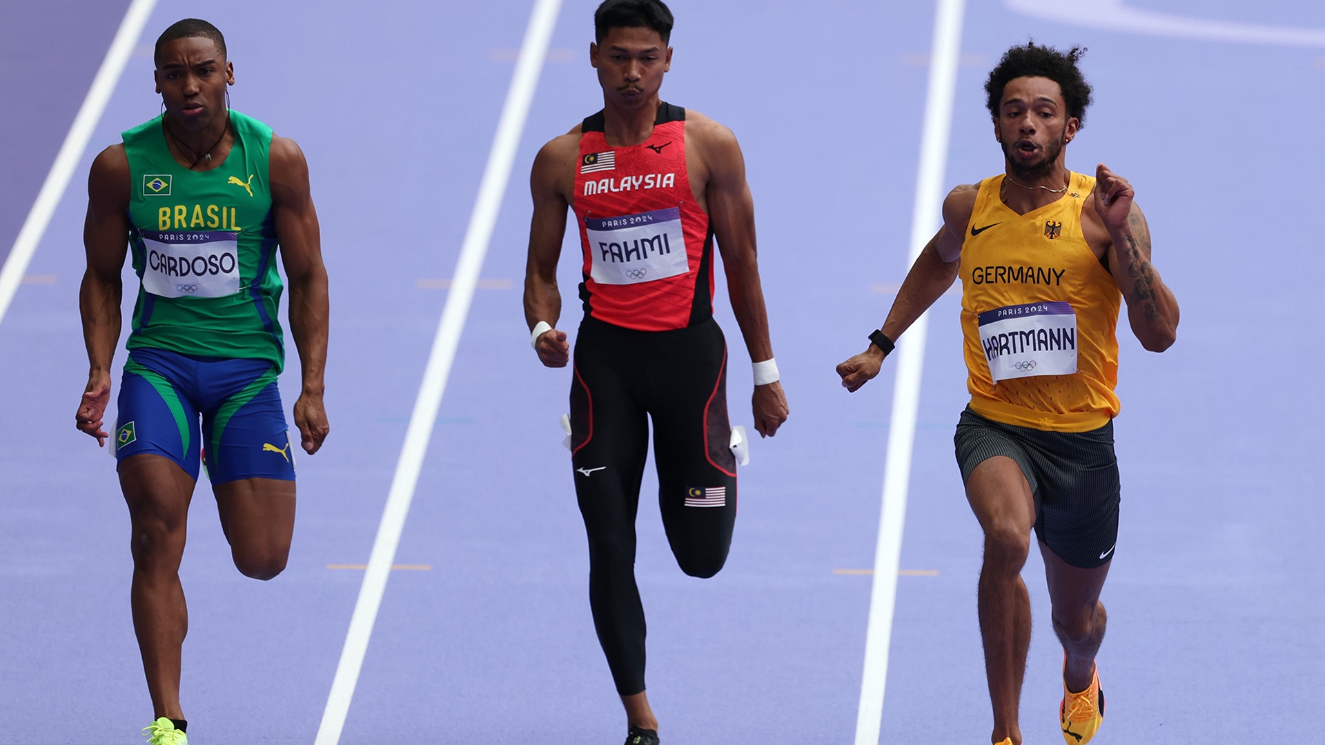 Auburn sprinter Azeem Fahmi (center) ran for Malaysia in the Paris Olympics