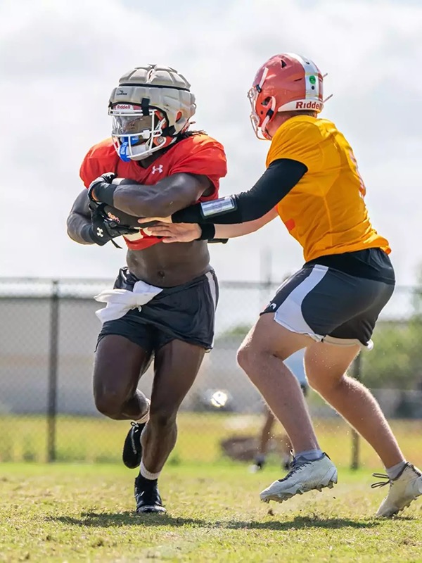 Djouvensky Schlenbaker takes a handoff from quarterback Eddie Lee Marburger at practice.
