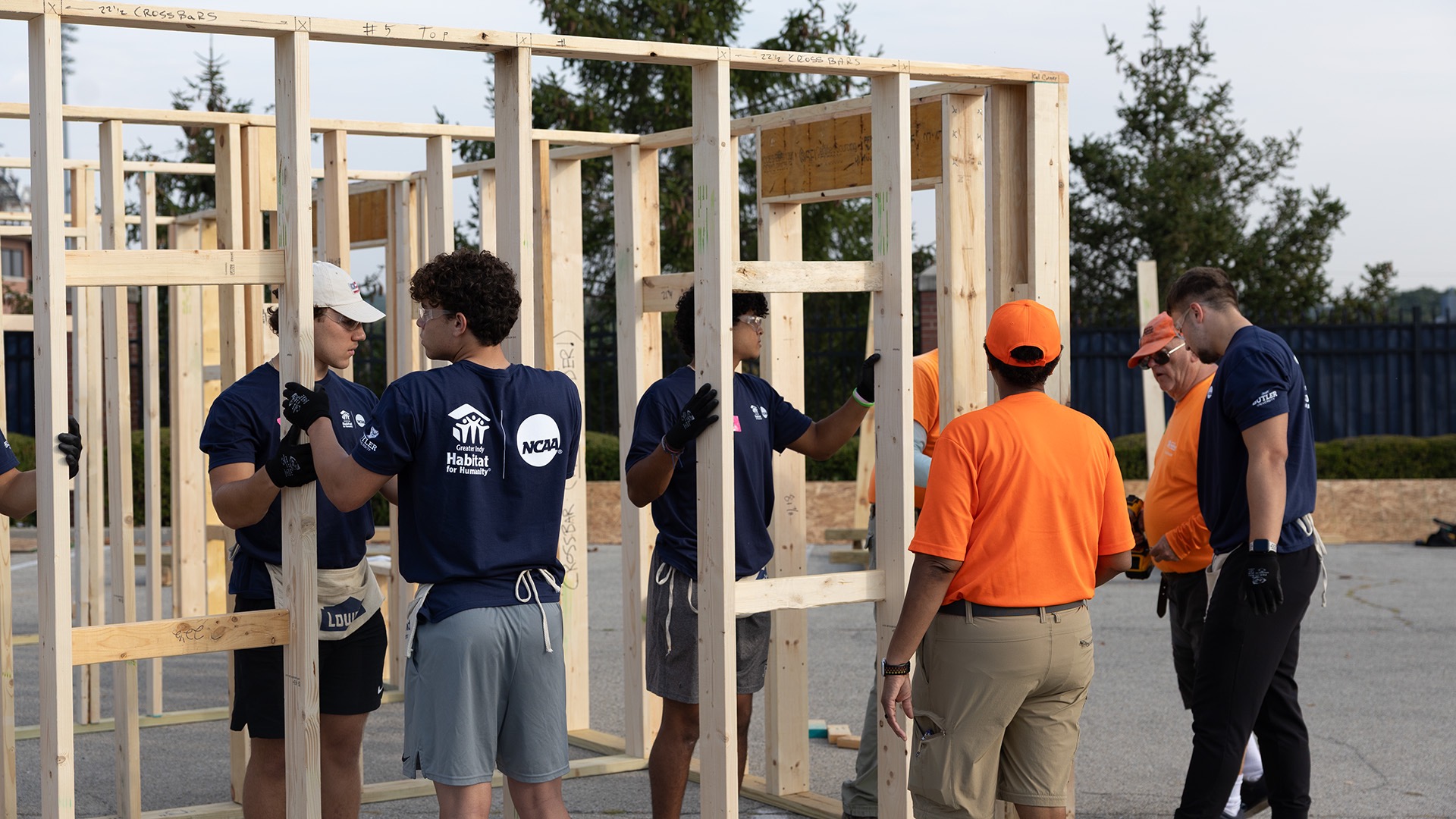 Butler baseball players hold up a constructed panel. Butler student-athletes and NCAA staff built panels for two complete homes. (Photos by Olivia Baumhoer / NCAA)
