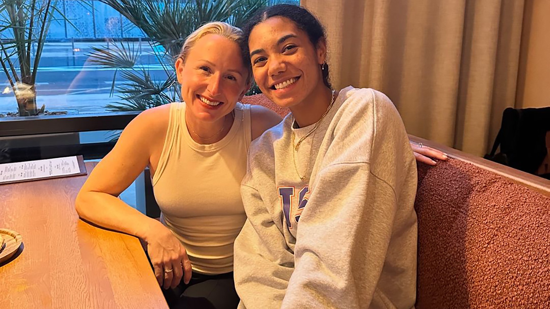 Thompson shares a moment with her former Cincinnati coach, Molly Alvey, in Paris during the 2024 Olympics, highlighting the strong mentorship that guided her journey from college standout to Olympic star. (Photo courtesy of Cincinnati)