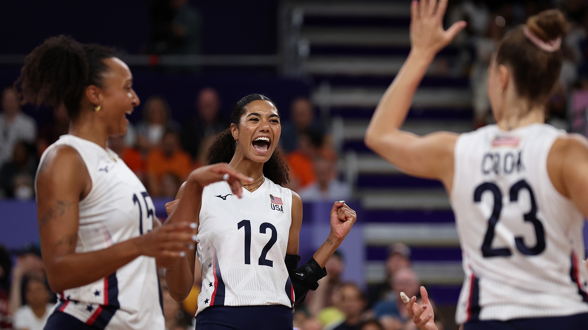 Thompson celebrates with teammates during the team's match against France, which the U.S. won 3-0 to move on to the quarterfinals Tuesday. (Photo by Steph Chambers / Getty Images)