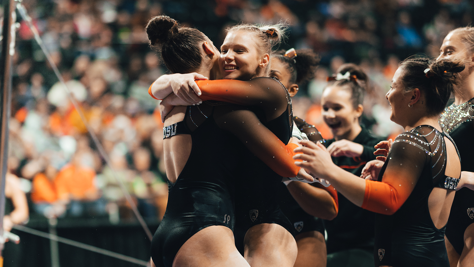Carey celebrates with her Oregon State teammates during a meet in 2022