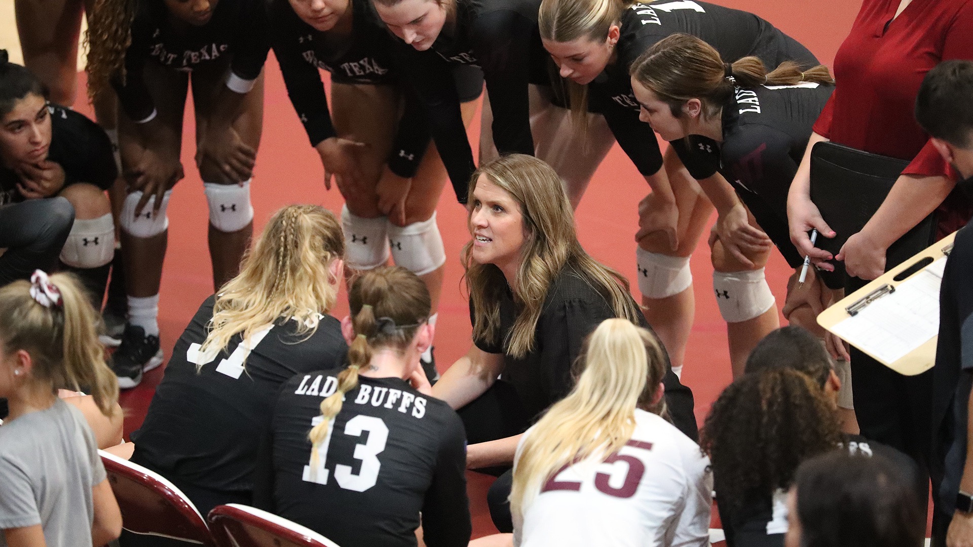 Head coach Kendra Potts huddles up with her team