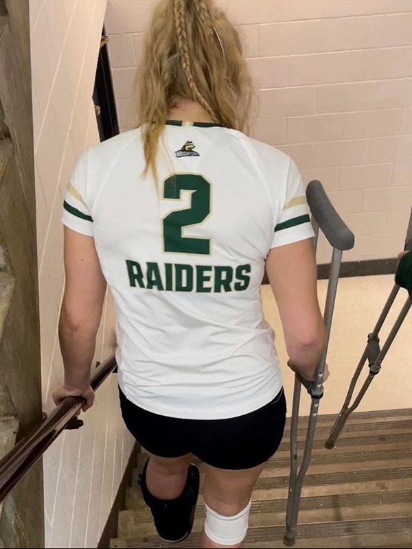 Wright State women's volleyball player Lainey Stephenson is shown walking down the stairs on crutches.