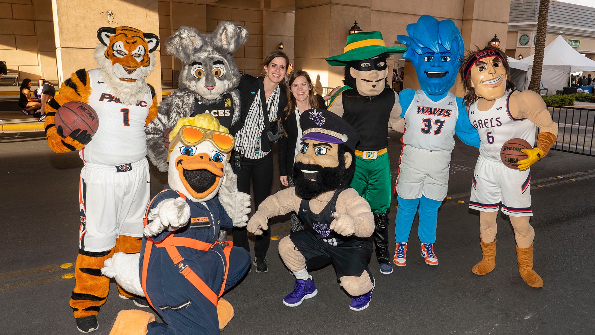 Gilligan, assistant commissioner of championships and administration for the West Coast Conference, shares a moment with several of the conference's school mascots. (Photo courtesy of Lauren Gilligan)