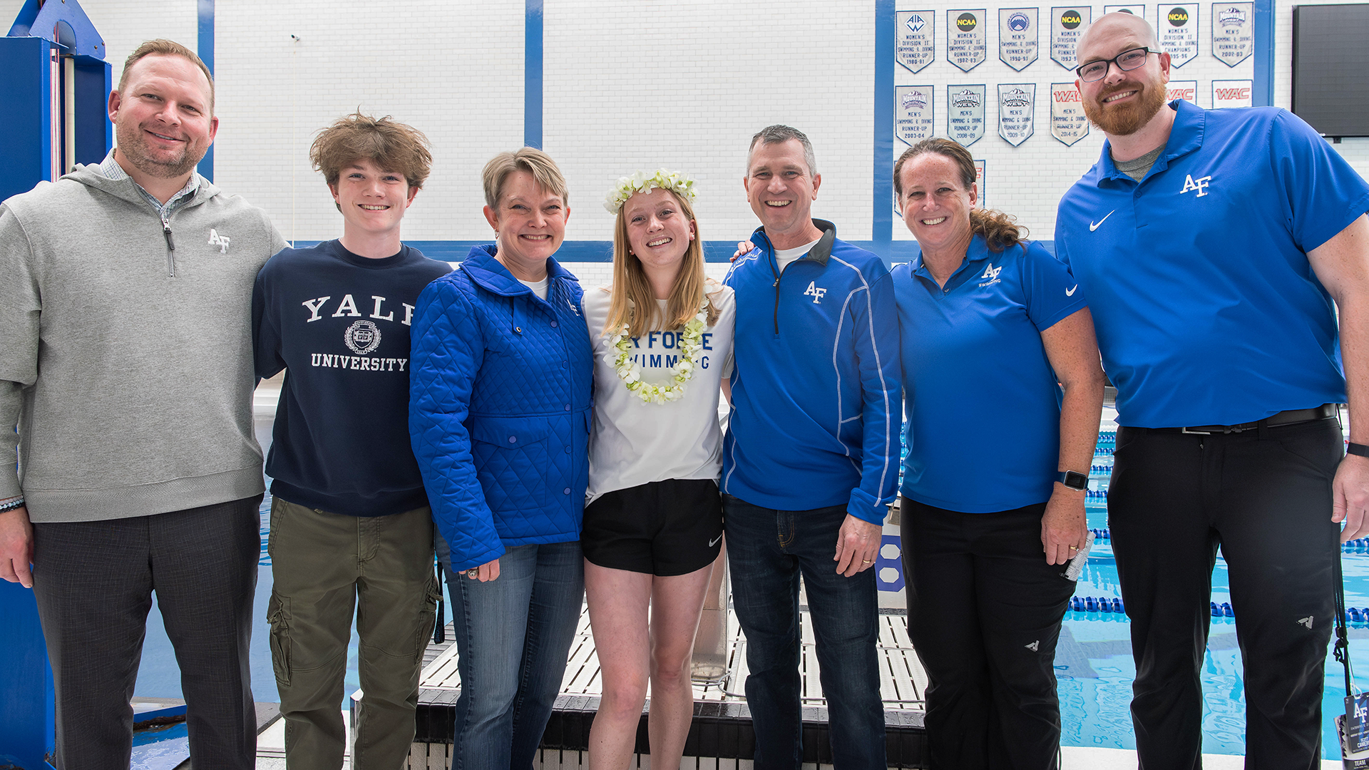 Madelyn Letendre shares a moment with her family and coaches at senior day. 