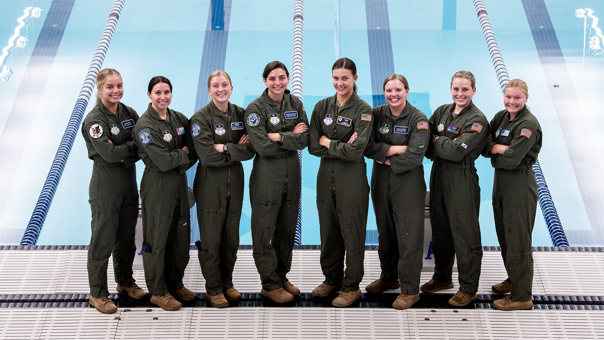 Madelyn Letendre and some of her teammates stand by the pool in their Air Force cadet uniforms. 