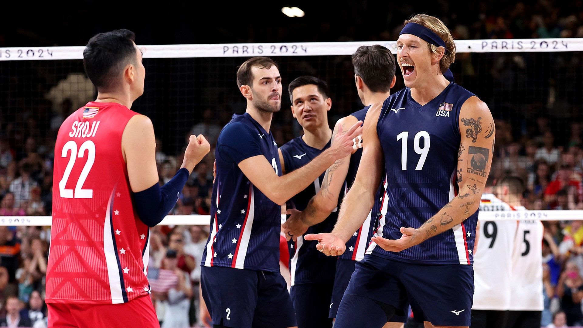 Taylor Averill (right) celebrates the U.S. team's pool play win against Germany with teammate Erik Shoji. (Photo by Christian Petersen / Getty Images)