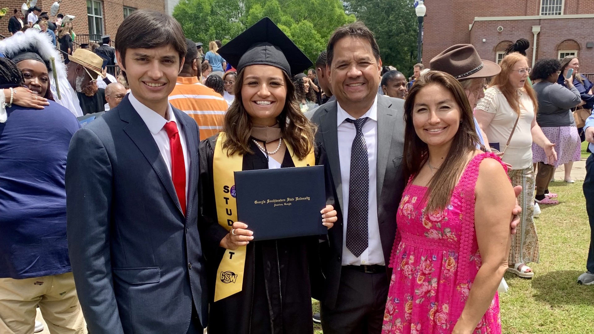 Herrera's brother, JJ; father, Jose; and mother, Lupita, celebrate her graduation from Georgia Southwestern.