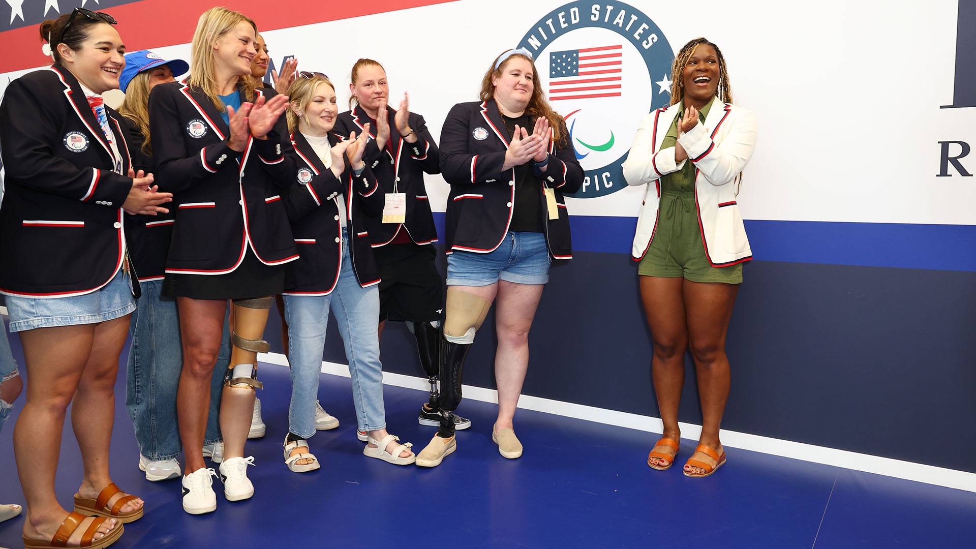 Nieves poses in a white blazer with fellow Team USA members after being named one of two Opening Ceremony flag bearers for the Paralympic Games in Paris. (Photo courtesy of Joe Scarnici / Getty Images for USOPC)