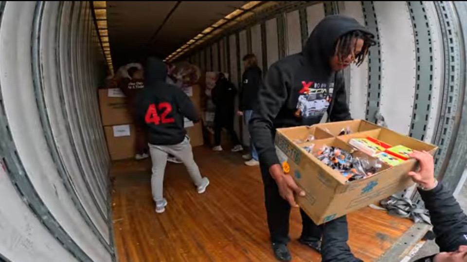 Students from Roberts Wesleyan unload boxes of toys