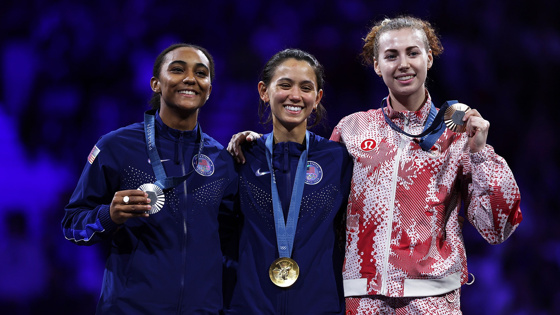 Scruggs (left) proudly displays her silver medal at the 2024 Paris Olympics, marking her as the second U.S. fencer in history to medal in the individual women's foil event