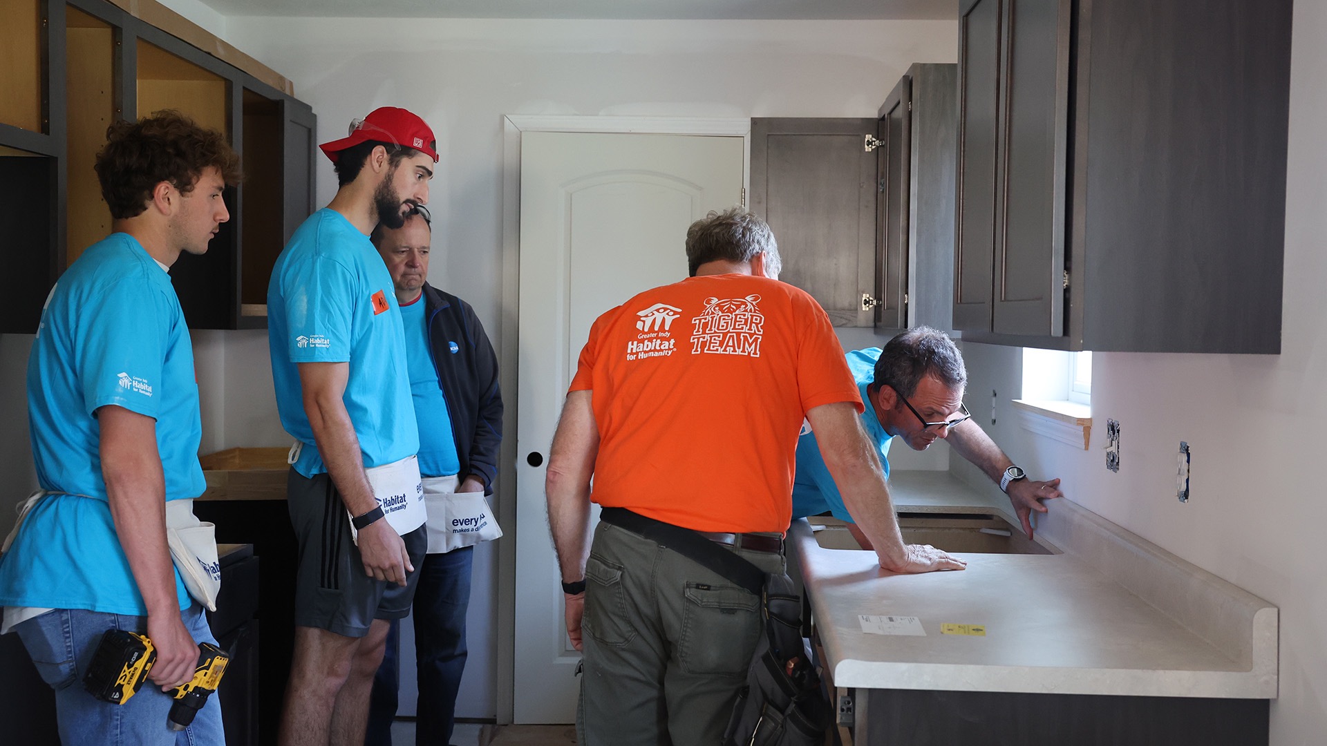 Student-athletes from Wabash work on the interior of a Habitat for Humanity home in May.
