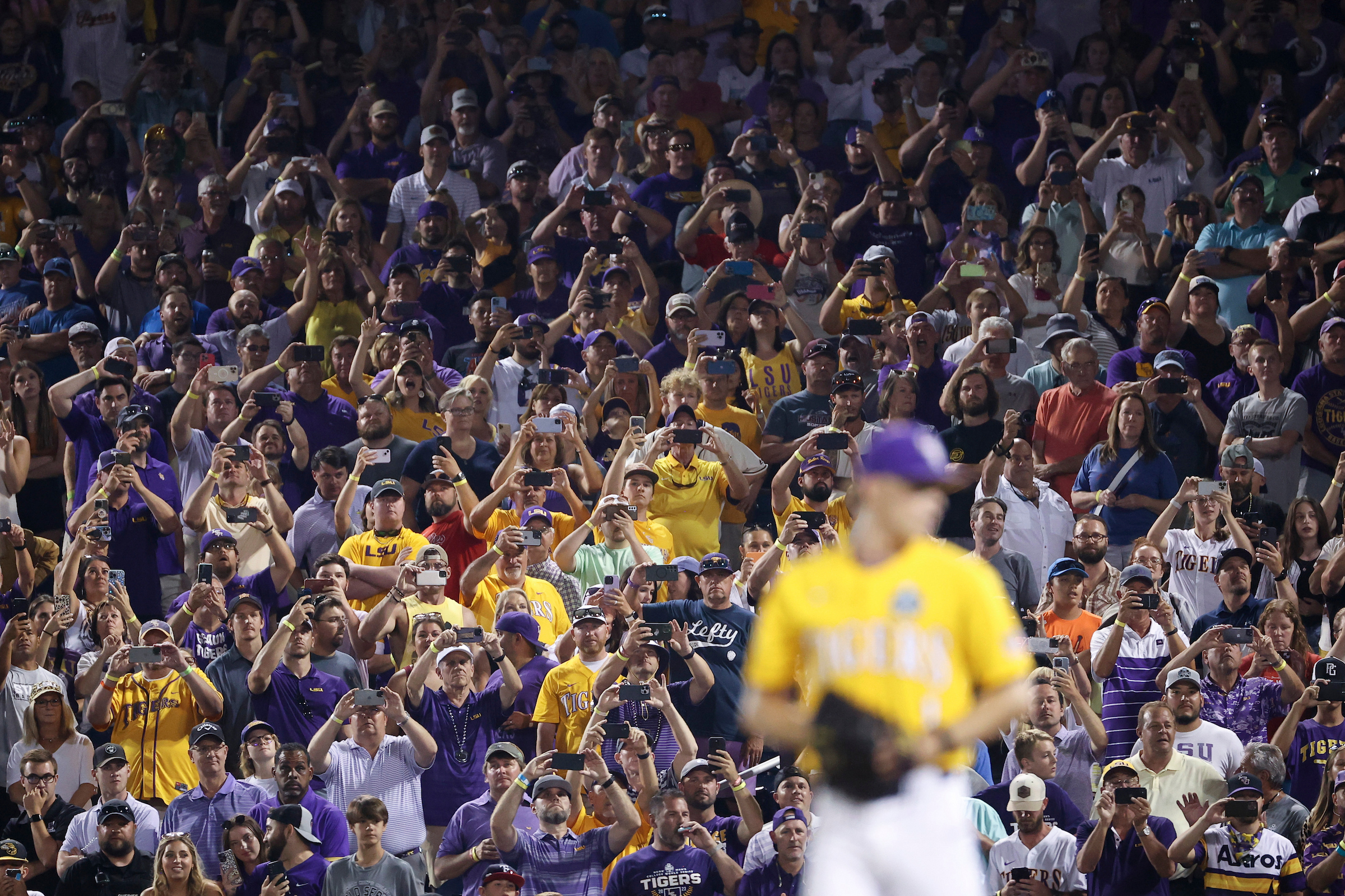 OMAHA, NE - JUNE 26: Fans prepare to record the final out on their phones during Game 3 of the Division I Men’s Baseball Championship finals between the LSU Tigers and the Florida Gators held at Charles Schwab Field on June 26, 2023 in Omaha, Nebraska. (Photo by Tyler Schank/NCAA Photos via Getty Images)