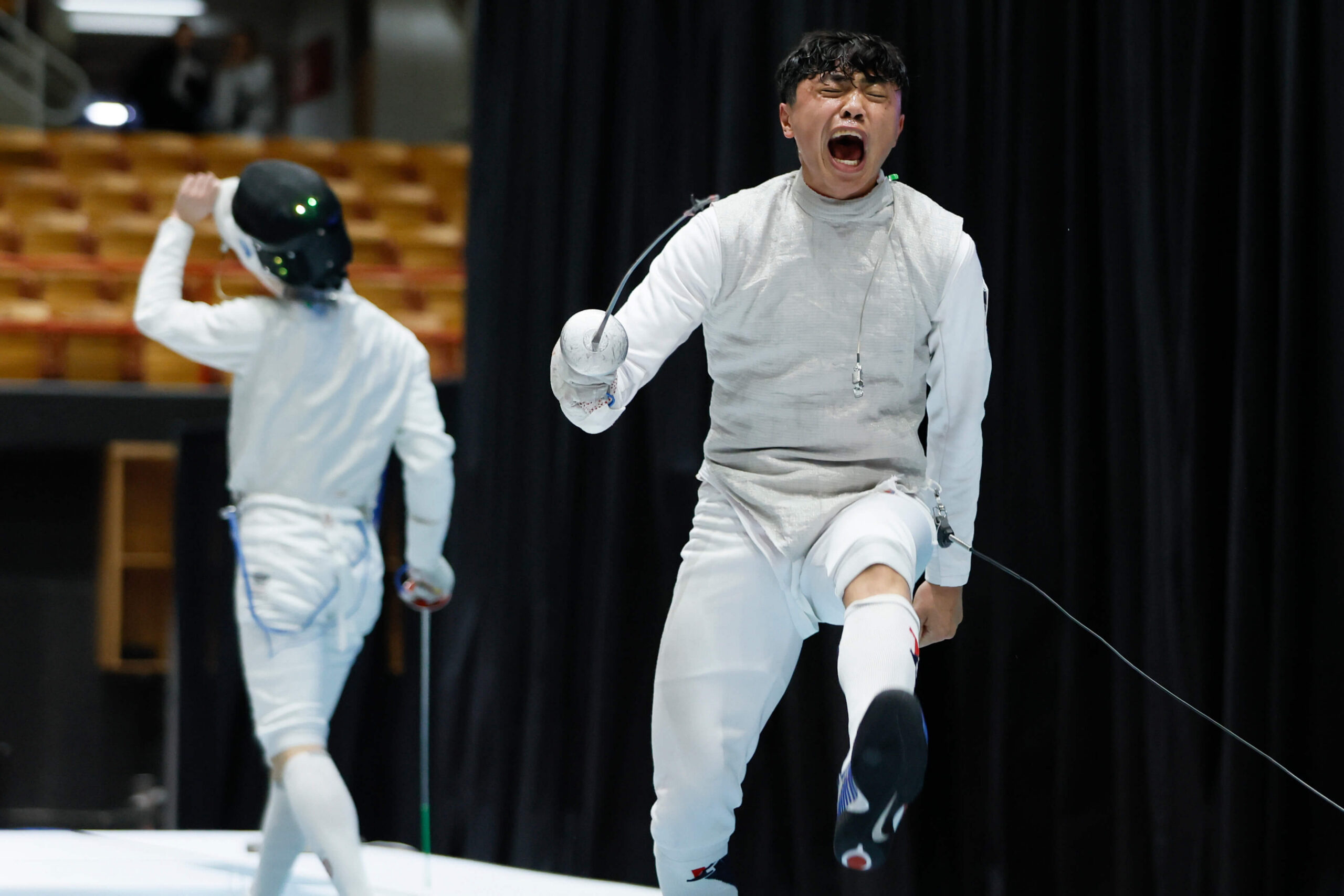 COLUMBUS, OHIO - MARCH 24: Daniel Zhang of the Harvard Crimson celebrates his win against Bryce Louie of the Penn Quakers in the semifinal foil competition during the Division I Men’s and Women’s Fencing Championships held at French Field House on March 24, 2024 in Columbus, Ohio. (Photo by Jay LaPrete/NCAA Photos/NCAA Photos via Getty Images)