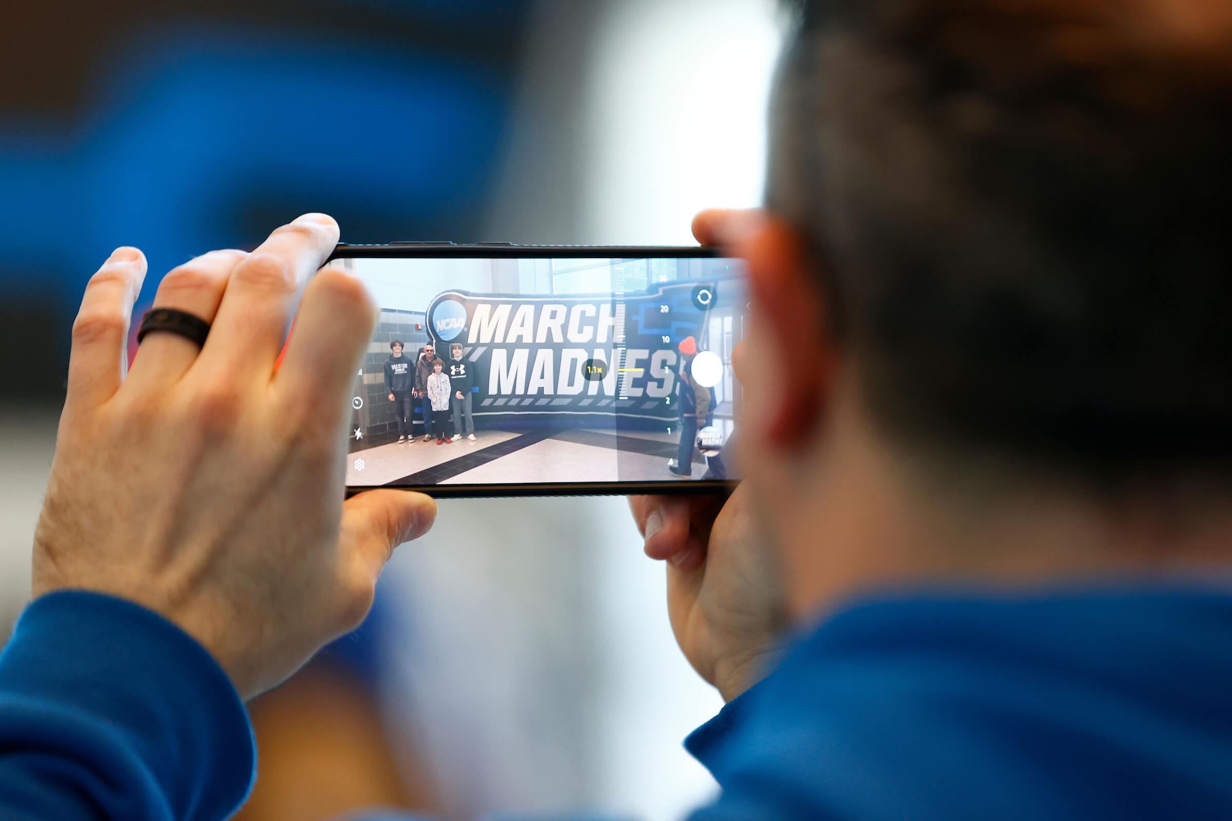 OMAHA, NEBRASKA - MARCH 21: A fan takes a photo with his phone ahead of the first round of the 2024 NCAA Men's Basketball Tournament held at CHI Health Center on March 21, 2024 in Omaha, Nebraska. (Photo by Brendall O'Banon/NCAA Photos via Getty Images)