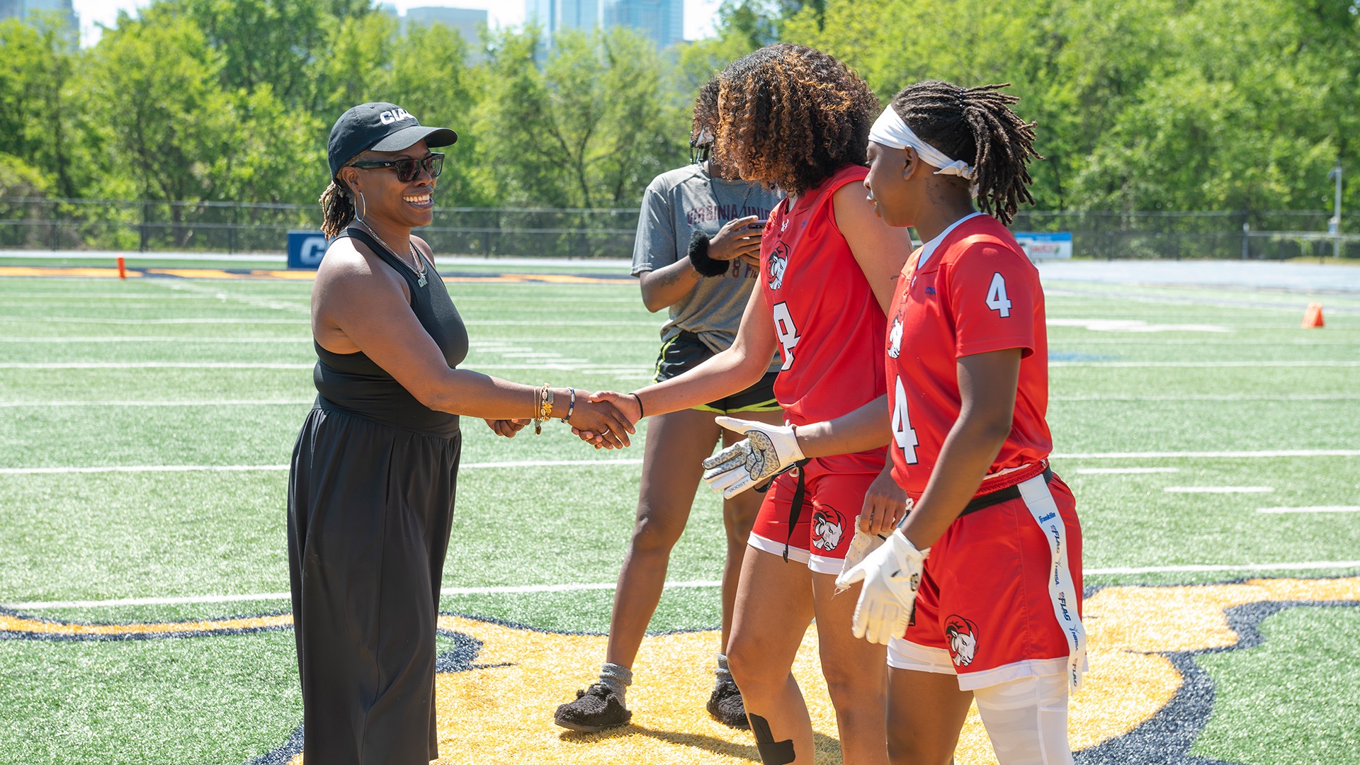 Central Intercollegiate Athletic Association Commissioner Jacqie McWilliams Parker (left) greets a flag football team at the conference tournament. (Photo by Keith Quick / Winston-Salem State)