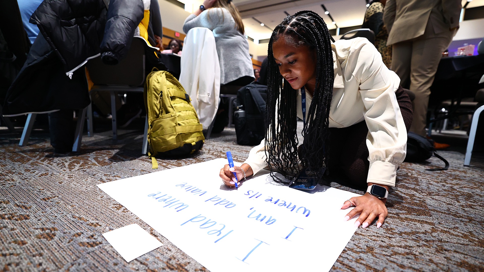 Elise Hopkins, a marketing assistant at the University of Louisiana at Lafayette, writes a statement during an activity.