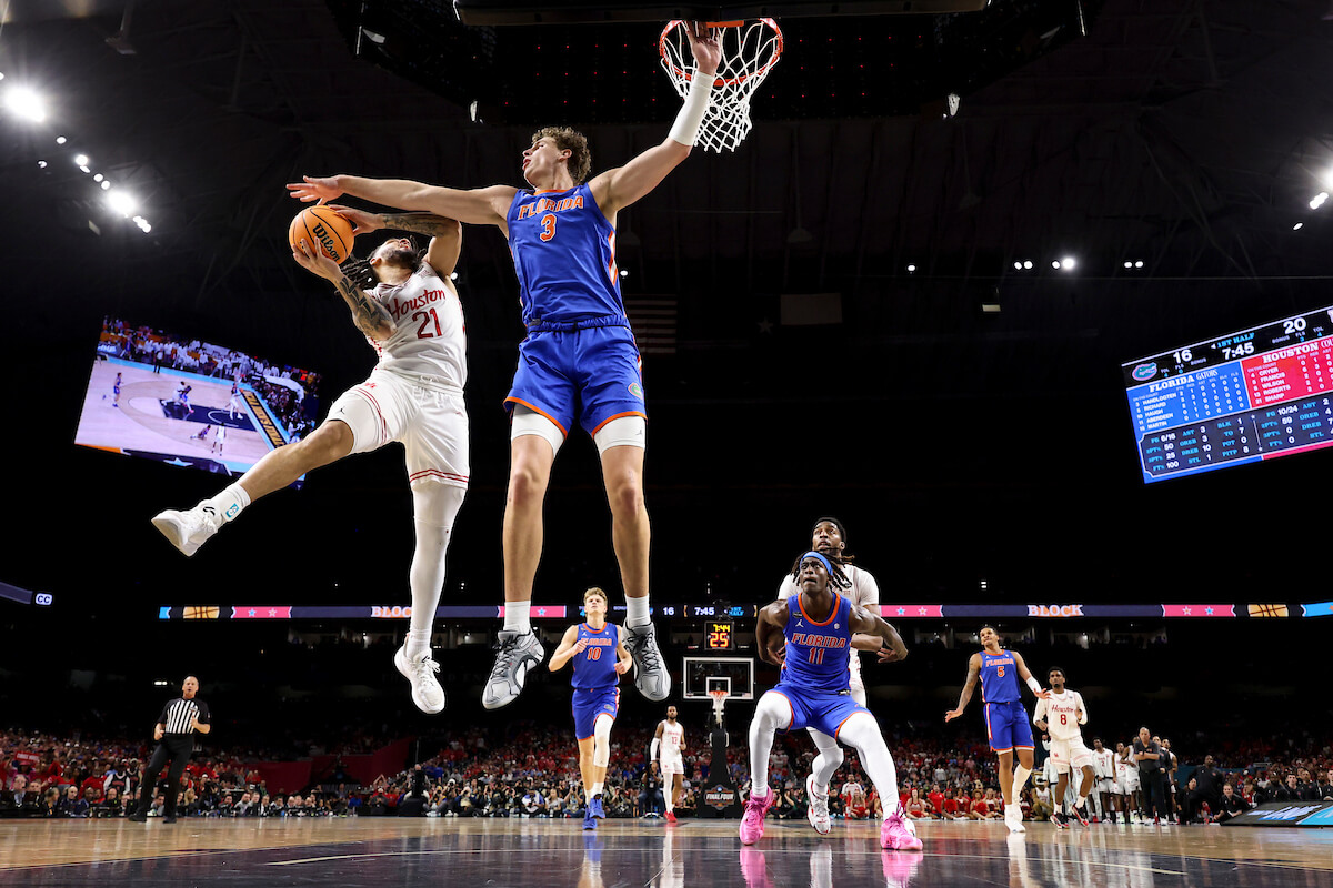 SAN ANTONIO, TEXAS - APRIL 07: Emanuel Sharp #21 of the Houston Cougars shoots the ball against Micah Handlogten #3 of the Florida Gators during the Division I Men's Basketball Championship game at Alamodome on April 07, 2025 in San Antonio, Texas. (Photo by Brett Wilhelm/NCAA Photos via Getty Images)