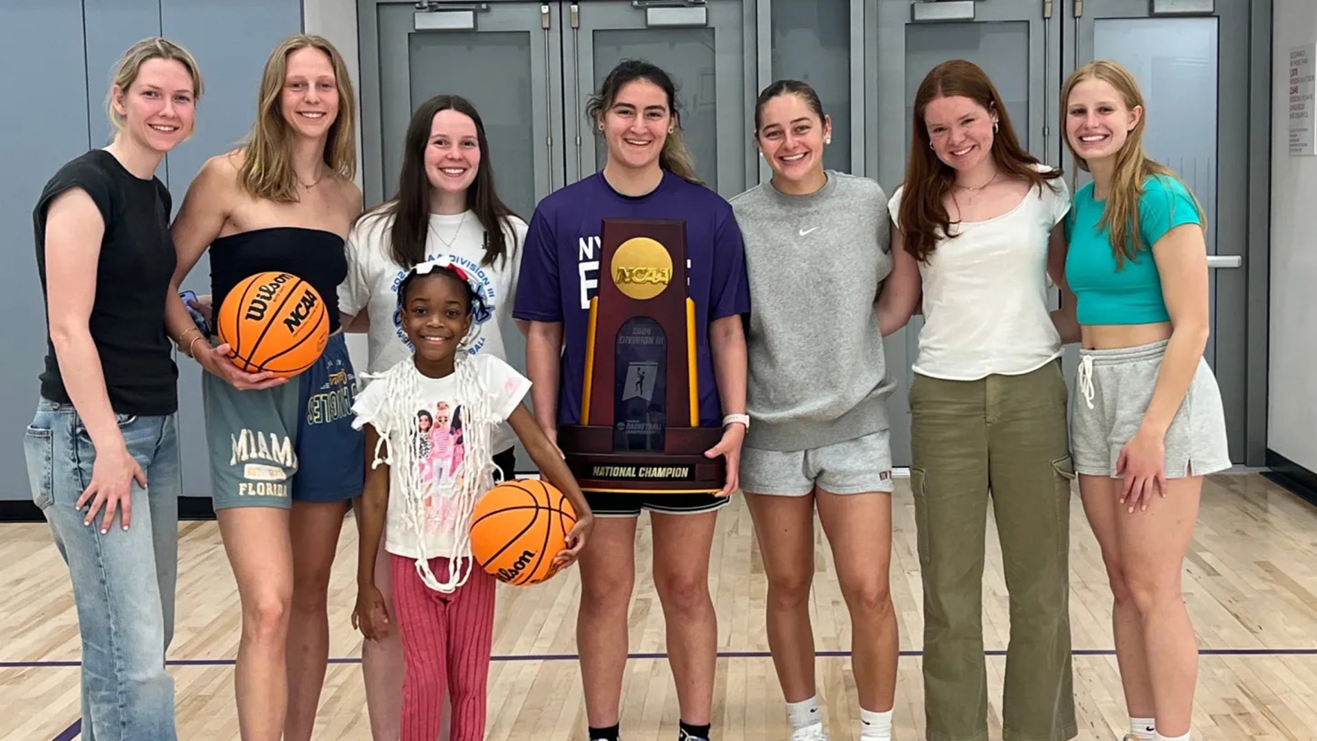 Eden Williamson (far right) poses with her NYU teammates and their Team IMPACT teammate, Amina, after being matched in 2024. (Photo courtesy of New York University)