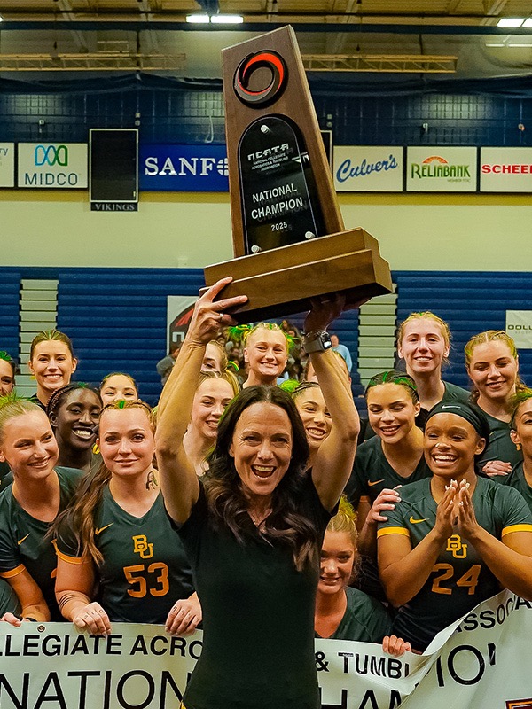 Felecia Mulkey stands with her team after Baylor won its 10th straight acrobatics and tumbling national championship in 2025. (Photos courtesy of Baylor)