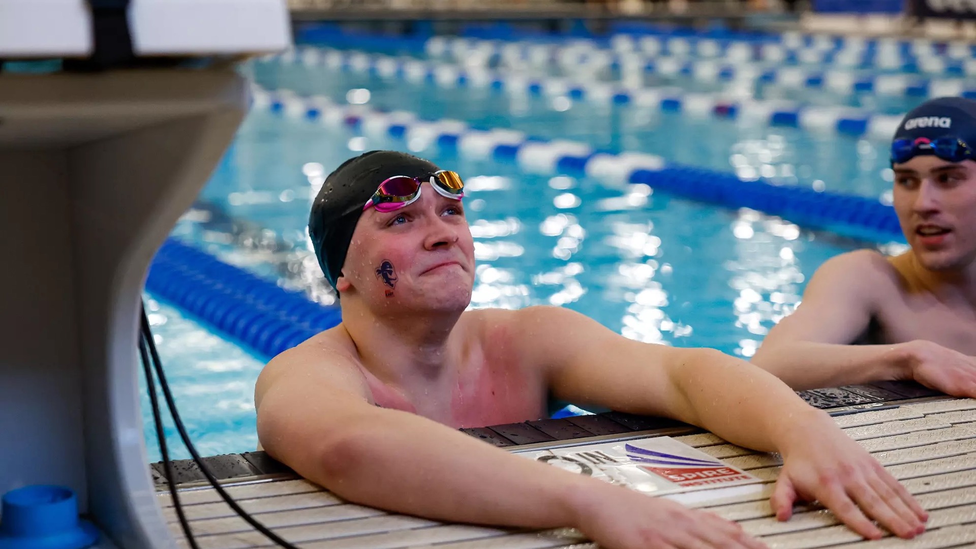 Kevin Cary resting on the wall in the aftermath of his 200 Freestyle BIG EAST Championship win