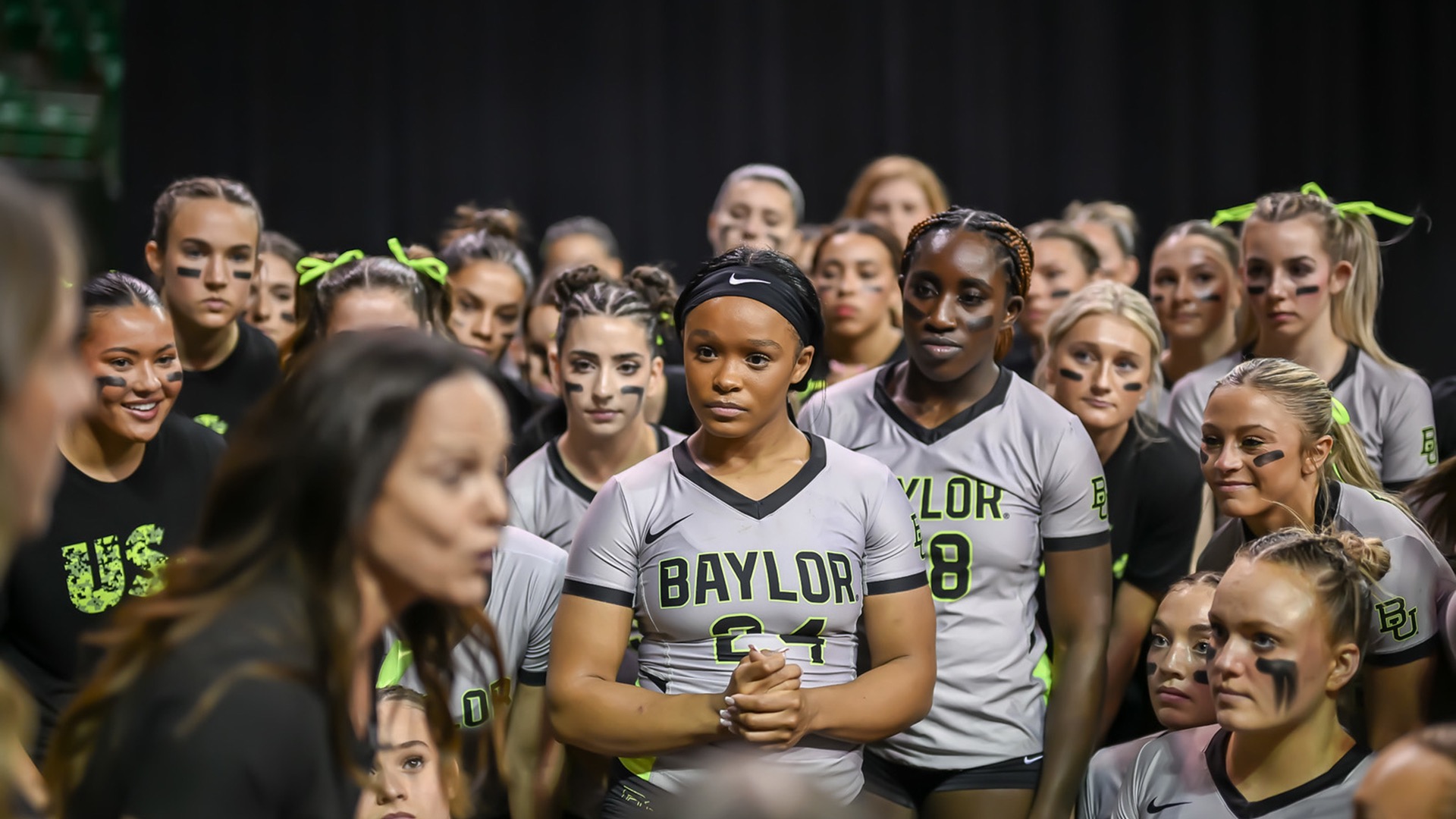Mariah Polk and her acrobatics and tumbling teammates listen to head coach Felecia Mulkey before a meet. (Photos courtesy of Mariah Polk)