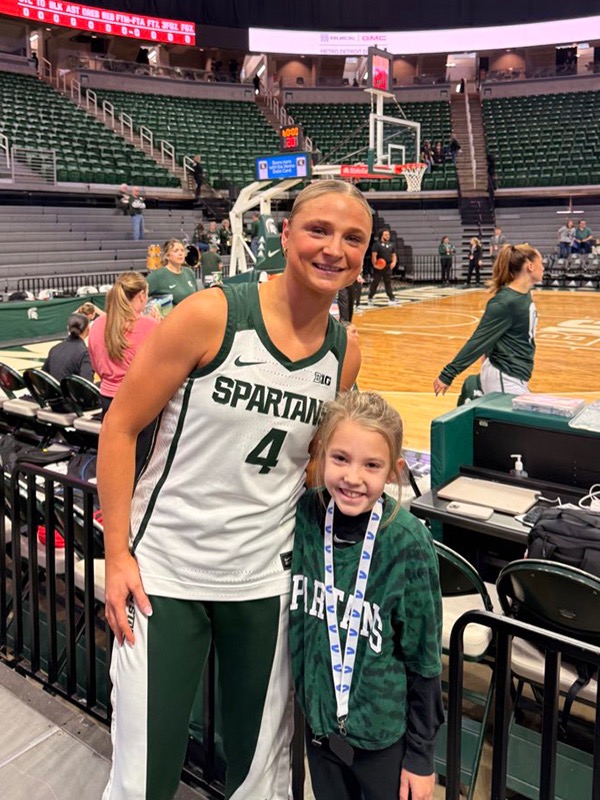 Michigan State's Theryn Hallock met Elliott after a game. Hallock said, "To read about her interests, struggles, what she does and enjoys was super interesting. To be able to build those connections, meet new people and put a smile on my face made my days better."