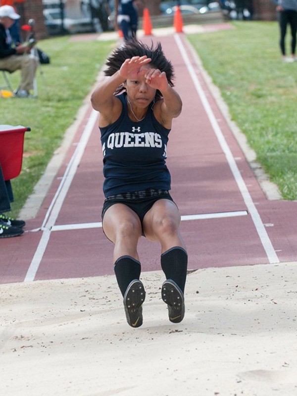 Ro competes in the long jump for Queens (North Carolina) at a meet. (Photo courtesy of Queens)