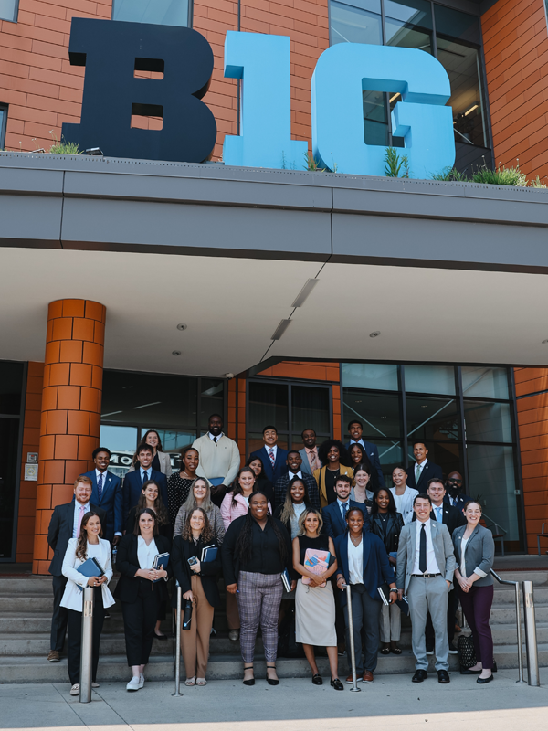 The 2023-24 NCAA postgraduate interns gather outside of the Big Ten Headquarters in Chicago.
